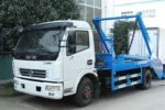 Side view of 4x2 swing arm garbage truck with body raised