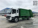 Rear compactor garbage truck on road