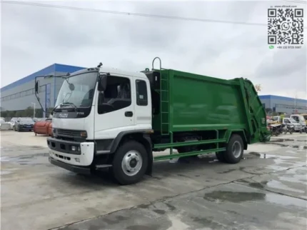 Rear compactor garbage truck on road