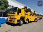 Sinotruk HOWO 8X4 rotator tow truck with extended crane arm ready for heavy recovery operations