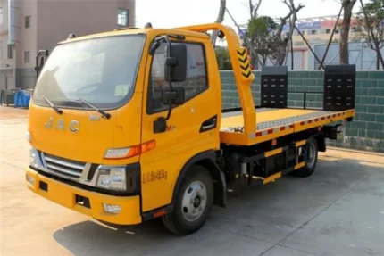 JAC 4 ton flatbed wrecker towing truck side view