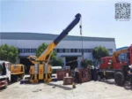 360-degree rotating crane boom on the Sinotruk HOWO 8X4 tow truck showing full articulation