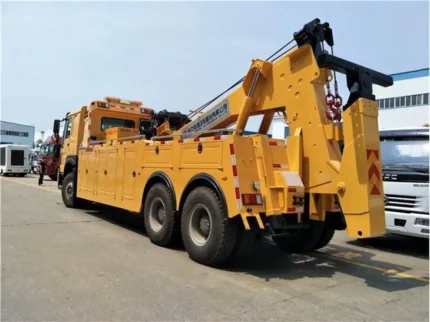 H type front outrigger and L type rear outrigger extended on wrecker truck
