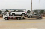Side view of Foton 4x2 wrecker showing towing winch and flatbed