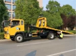Hydraulic loading arm and winch system on the flatbed tow truck