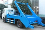 Swing arm mechanism lifting garbage container onto truck