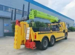 Wrecker truck boom arm in folded position ready for recovery work