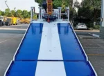 Remote control operation of crane on flatbed recovery truck