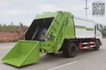 Factory floor showing finished compactor garbage truck ready for shipment