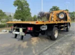 Rear view showing 7 radial steel tires and spare wheel