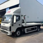 Flatbed tow truck front three quarter view with JAC branding