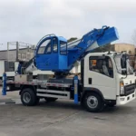 Rear view of the bucket truck displaying the folded boom and truck equipment storage