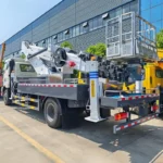 Two operators working in elevated boom bucket position